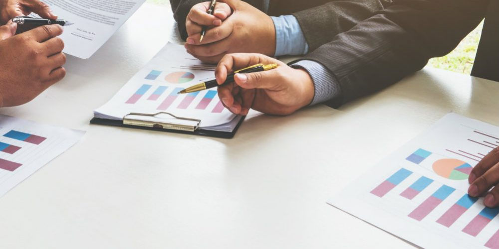 Alcuni professionisti controllano grafici e tabelle sui risultati aziendali