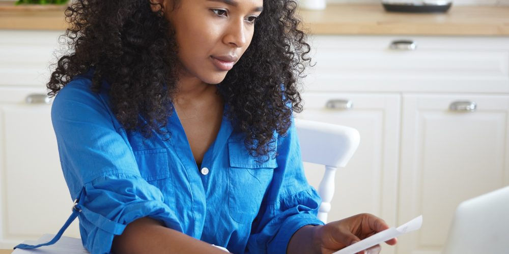 Una ragazza controlla la bolletta del gas: avere una guida per la bolletta ci permette di risparmiare