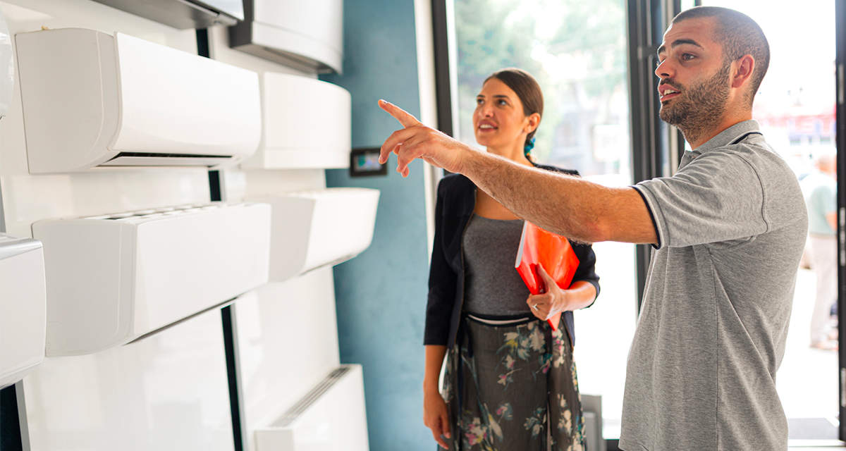 Un tecnico aiuta una donna a scegliere il climatizzatore